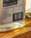 Orange Oil Tincture Square Bottle on a Wooden Board with Herbs Mockup