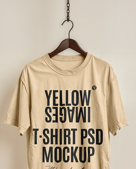 T-Shirt on a Wooden Hanger Against a Plain Background Mockup
