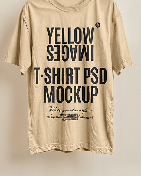 T-Shirt on a Wooden Hanger Against a Plain Background Mockup