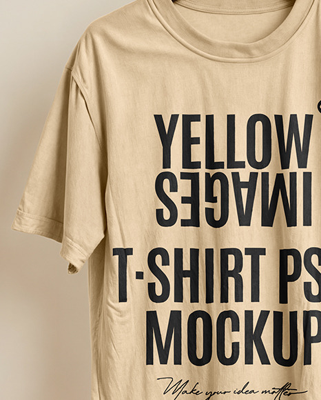 T-Shirt on a Wooden Hanger Against a Plain Background Mockup