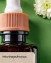 Amber Oil Tincture Square Bottle with Flowers and Green Backdrop Mockup