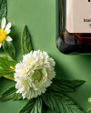 Amber Oil Tincture Square Bottle with Flowers and Green Backdrop Mockup