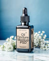 Dark Amber Oil Tincture Square Bottle on a Marble Surface with Flowers Mockup