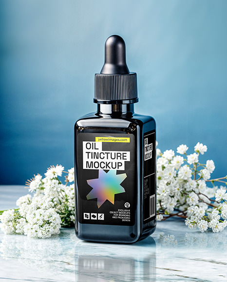 Dark Amber Oil Tincture Square Bottle on a Marble Surface with Flowers Mockup