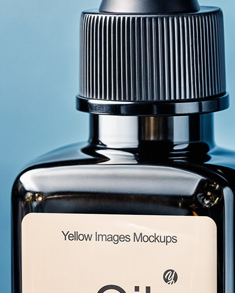 Dark Amber Oil Tincture Square Bottle on a Marble Surface with Flowers Mockup
