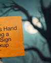 Mummy's Hand Holding a Paper Sign Mockup