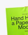 A Hand Holding a Paper Sign with Wooden Handle Mockup