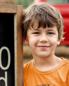 Boy Standing Next to Wooden Framed Sign at Pumpkin Patch Mockup