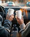 Two People in a Сar Holding Coffee Cups in Their Hands Mockup