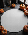 Round Rug on Wooden Floor Surrounded by Pumpkins Mockup