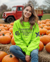Young Woman in Sweatshirt Sitting on Hay Block with Pumpkins Around Mockup