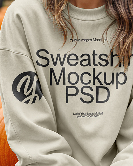 Young Woman in Sweatshirt Sitting on Hay Block with Pumpkins Around Mockup