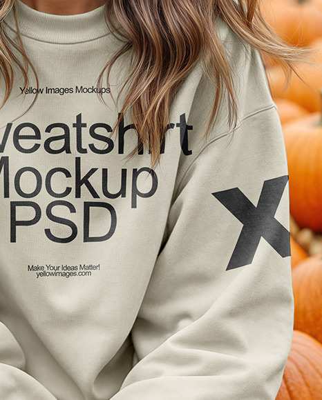 Young Woman in Sweatshirt Sitting on Hay Block with Pumpkins Around Mockup