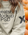 Young Woman in Sweatshirt Sitting on Hay Block with Pumpkins Around Mockup