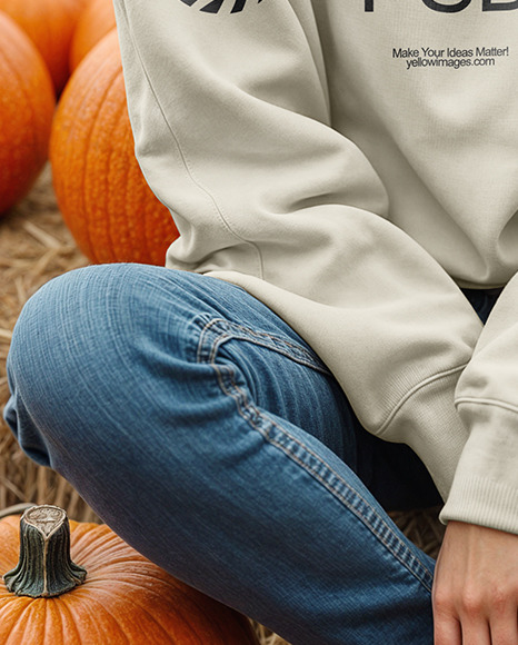 Young Woman in Sweatshirt Sitting on Hay Block with Pumpkins Around Mockup