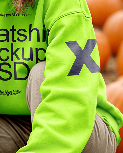 Young Woman in Sweatshirt and Beanie Sitting Next to Pumpkins Mockup