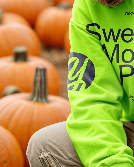 Young Woman in Sweatshirt and Beanie Sitting Next to Pumpkins Mockup