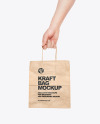 Hand w/ Paper Bag Mockup
