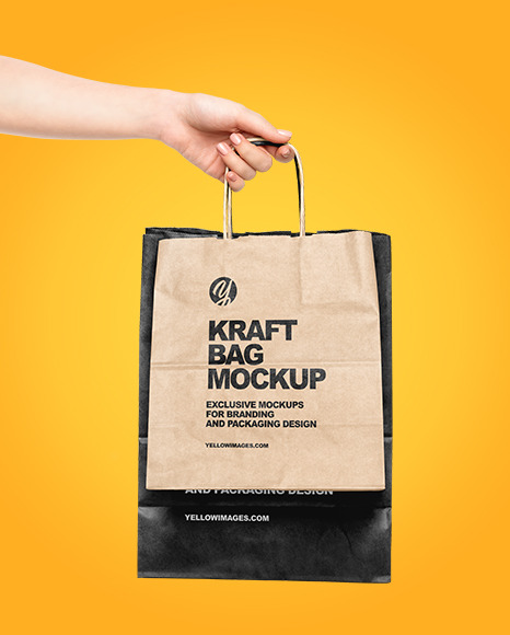 Hand w/ Two Paper Bags Mockup