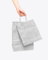 Hand w/ Two Paper Bags Mockup