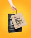 Hand w/ Two Paper Bags Mockup