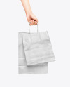 Hand w/ Two Paper Bags Mockup