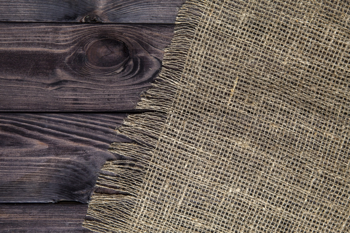 Rustic burlap on wooden table Rustic burlap on wooden table
